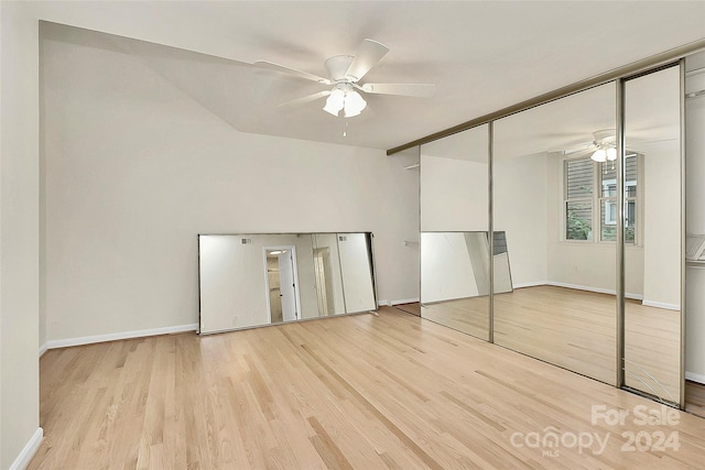 unfurnished bedroom with light hardwood / wood-style floors, ceiling fan, and a closet