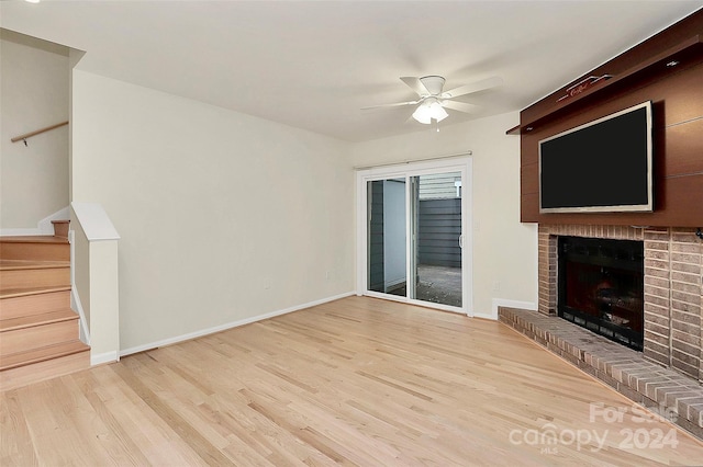 unfurnished living room with ceiling fan, light hardwood / wood-style flooring, and a fireplace