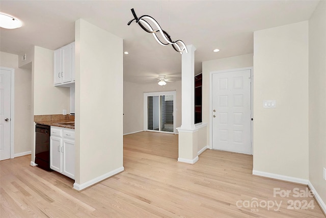 kitchen featuring light hardwood / wood-style flooring, white cabinets, and black dishwasher