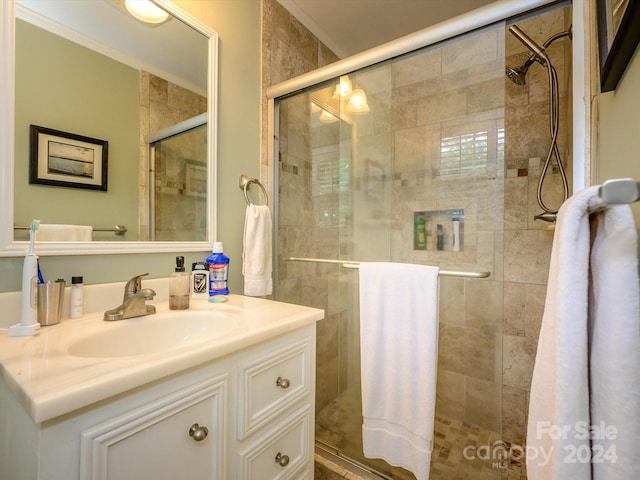 bathroom featuring vanity and a shower with shower door