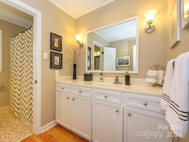 bathroom with walk in shower, crown molding, vanity, and hardwood / wood-style flooring