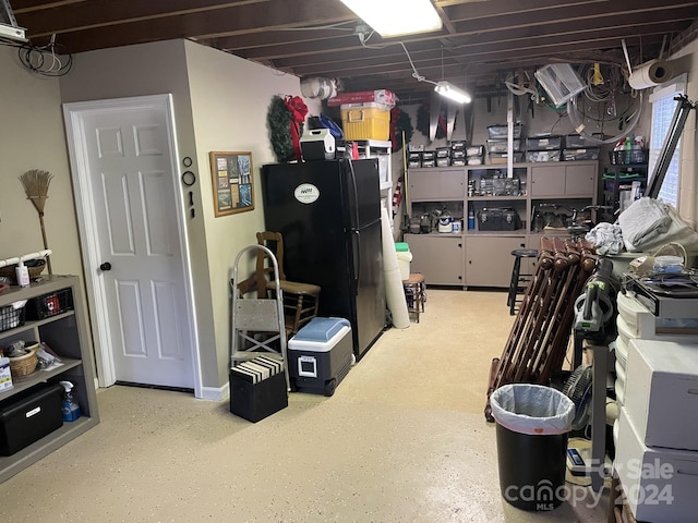 basement with black refrigerator