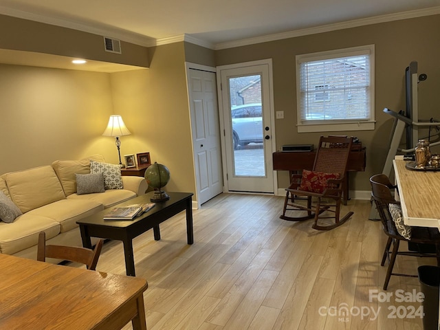 living room featuring light wood-type flooring and crown molding