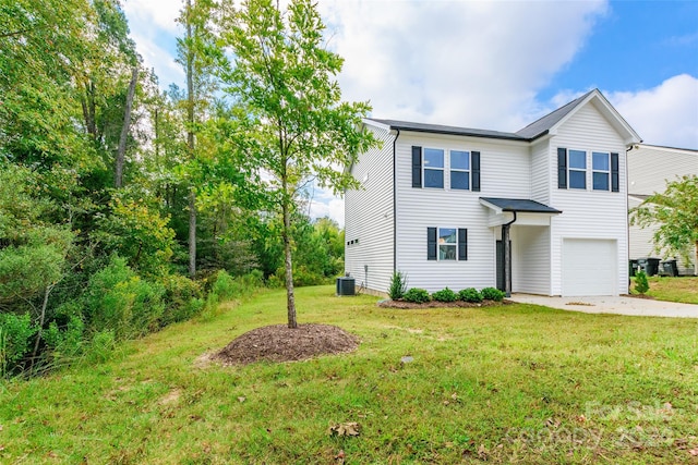 view of front of property featuring central AC, a garage, and a front lawn