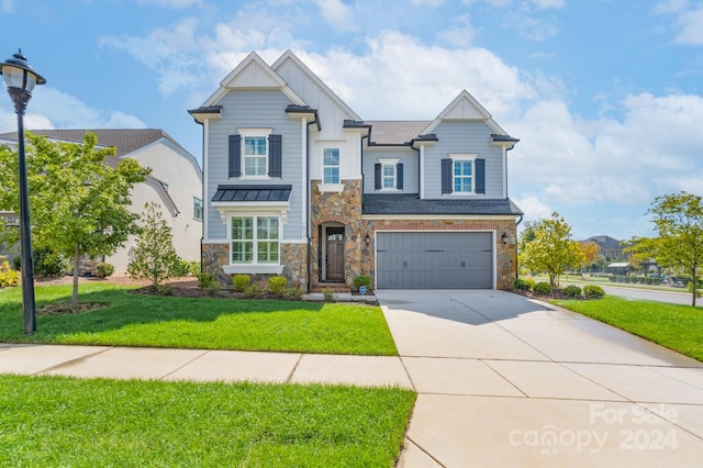 view of front of property with a garage and a front yard