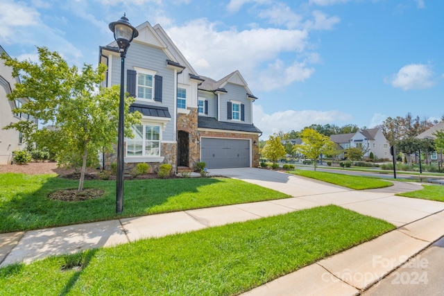 view of front of property featuring a front yard and a garage