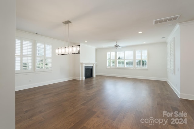 unfurnished living room with ornamental molding, ceiling fan, and dark wood-type flooring