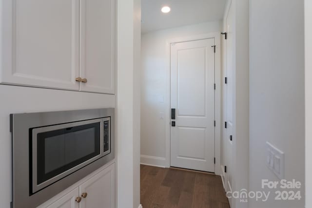 corridor with dark hardwood / wood-style floors