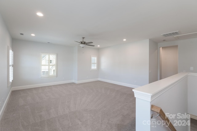 unfurnished room featuring light carpet and ceiling fan