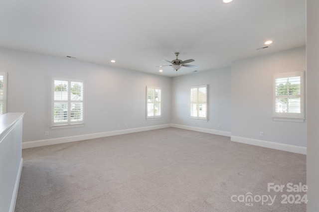 carpeted empty room with ceiling fan