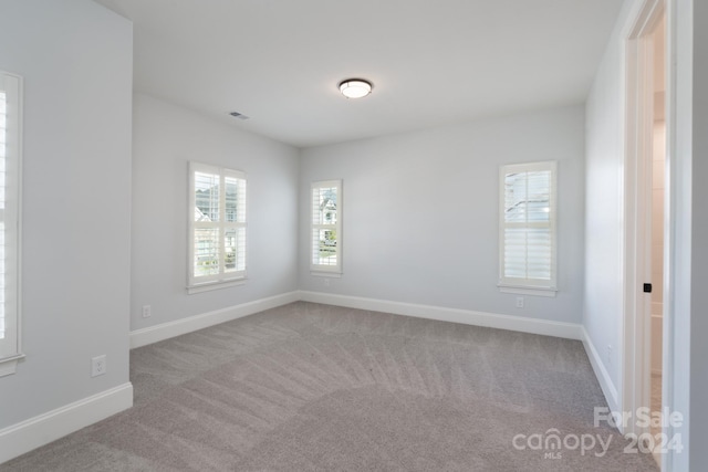 spare room with light colored carpet