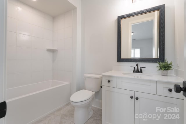 full bathroom with tile patterned floors, tiled shower / bath, vanity, and toilet