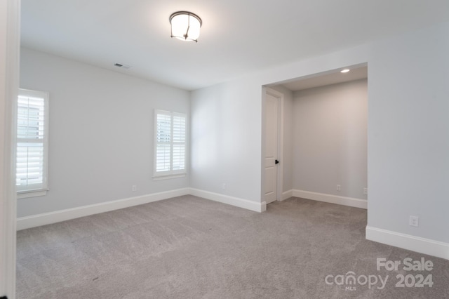 spare room with a healthy amount of sunlight and light colored carpet