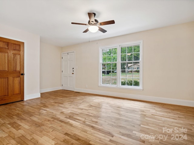 unfurnished room with light wood-type flooring and ceiling fan