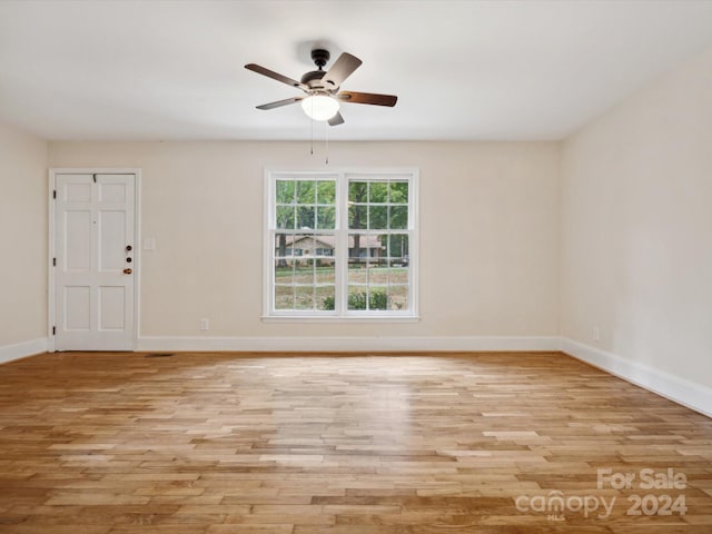 spare room featuring ceiling fan and light hardwood / wood-style flooring