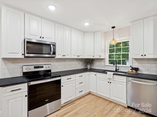 kitchen featuring white cabinets, appliances with stainless steel finishes, and sink