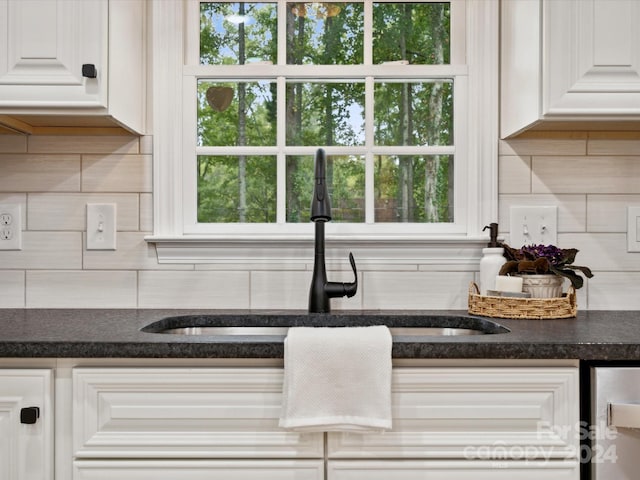 kitchen featuring white cabinetry, tasteful backsplash, and sink