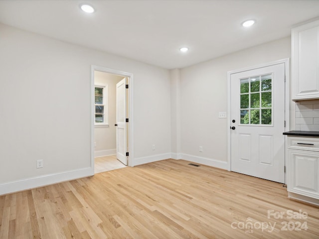 unfurnished dining area featuring light hardwood / wood-style floors