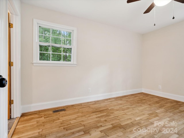 unfurnished room featuring ceiling fan and light wood-type flooring