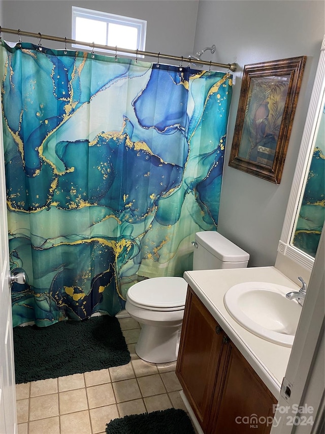 bathroom featuring a shower with shower curtain, tile patterned floors, vanity, and toilet