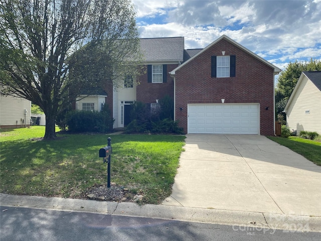 view of front facade with a front yard and a garage