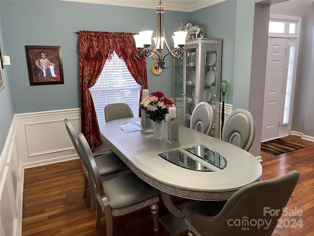 dining area featuring a notable chandelier, ornamental molding, dark hardwood / wood-style flooring, and a wealth of natural light