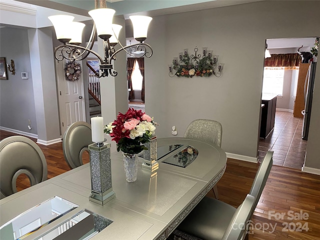 dining room featuring dark wood-type flooring and a notable chandelier