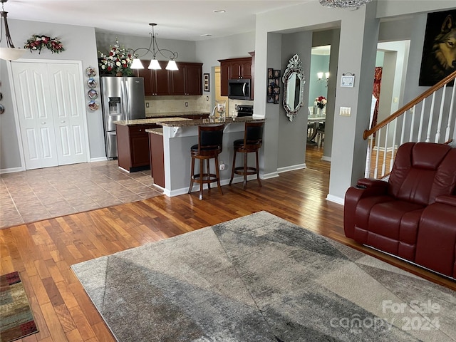 living room featuring light wood-type flooring and sink