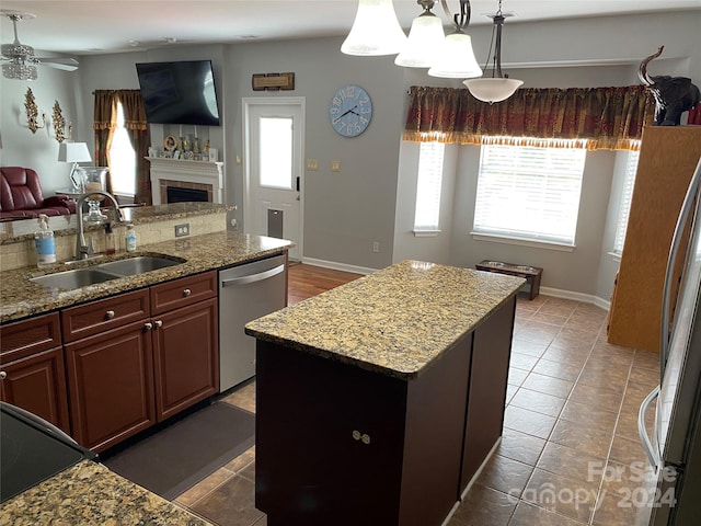 kitchen featuring a kitchen island, dishwasher, sink, and a wealth of natural light