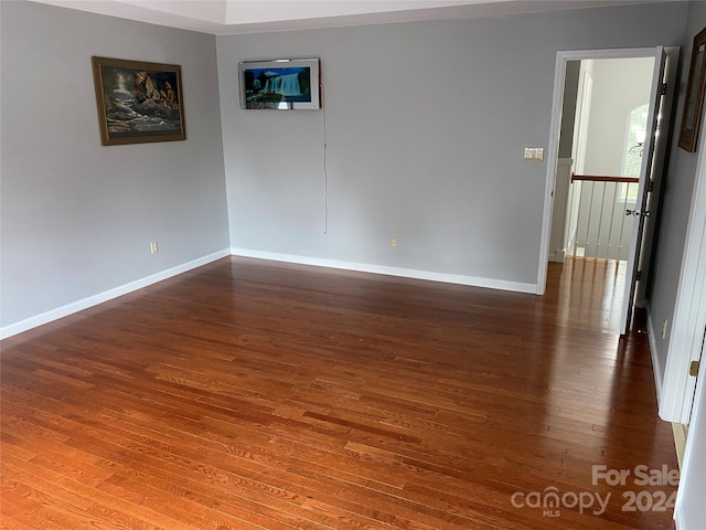 spare room featuring dark hardwood / wood-style flooring