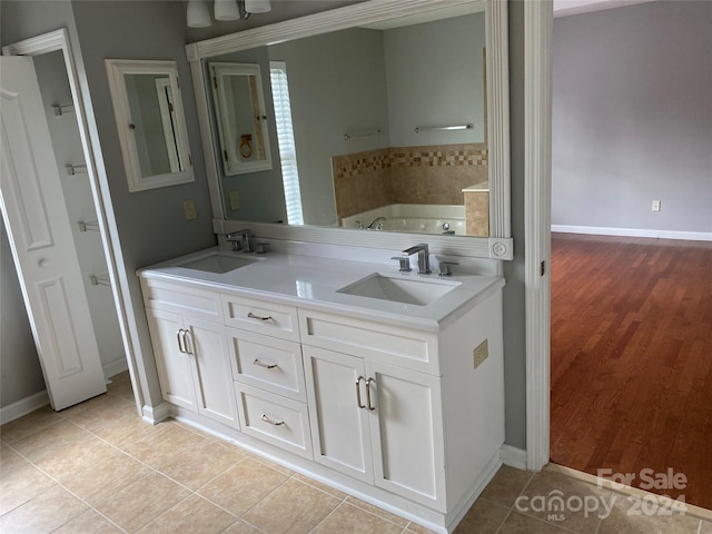 bathroom with vanity, a bathing tub, and tile patterned floors