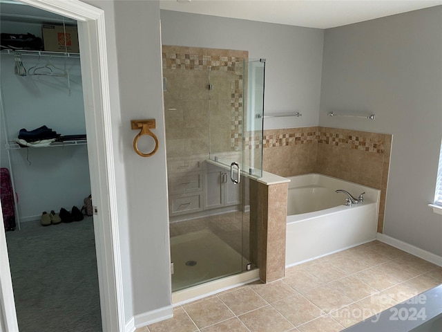 bathroom featuring tile patterned flooring and separate shower and tub