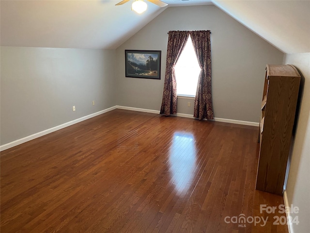 bonus room with lofted ceiling, dark hardwood / wood-style flooring, and ceiling fan