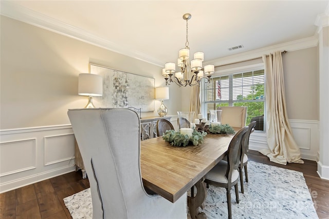 dining space with crown molding, dark hardwood / wood-style floors, and a notable chandelier