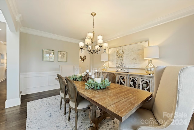 dining area featuring crown molding, a notable chandelier, and dark hardwood / wood-style flooring