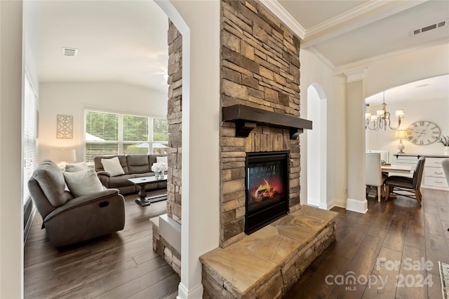 living room featuring a stone fireplace, lofted ceiling, dark wood-type flooring, and crown molding