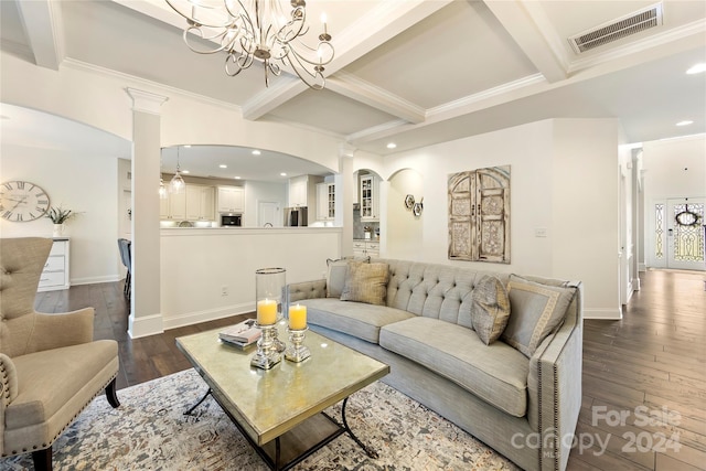 living room featuring beam ceiling, decorative columns, crown molding, an inviting chandelier, and dark hardwood / wood-style flooring