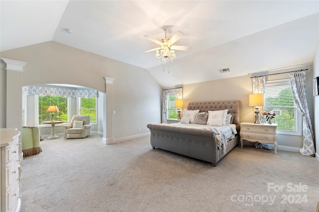 bedroom featuring carpet, vaulted ceiling, multiple windows, and ceiling fan