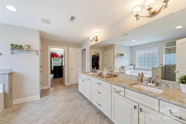 bathroom featuring vanity, a notable chandelier, independent shower and bath, and tile patterned floors