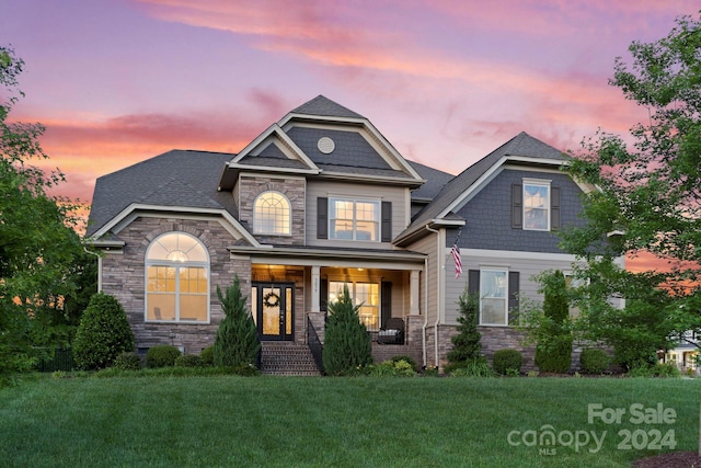 craftsman-style home with a yard and a porch