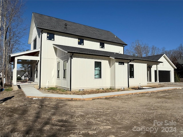 back of house featuring a garage