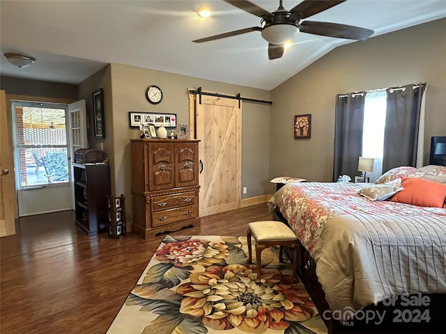 bedroom with ceiling fan, vaulted ceiling, a barn door, and dark hardwood / wood-style flooring