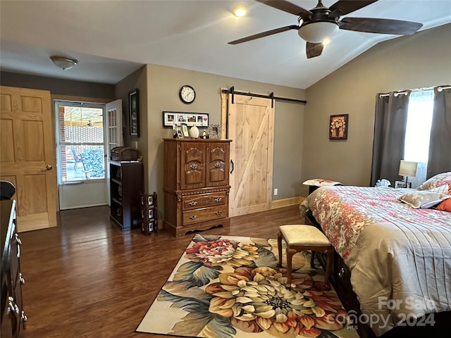 bedroom featuring a barn door, lofted ceiling, dark hardwood / wood-style flooring, and ceiling fan