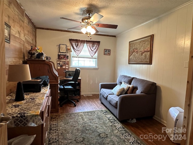 office featuring ornamental molding, ceiling fan, dark wood-type flooring, and a textured ceiling