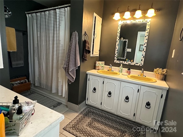 bathroom with vanity, curtained shower, and tile patterned floors