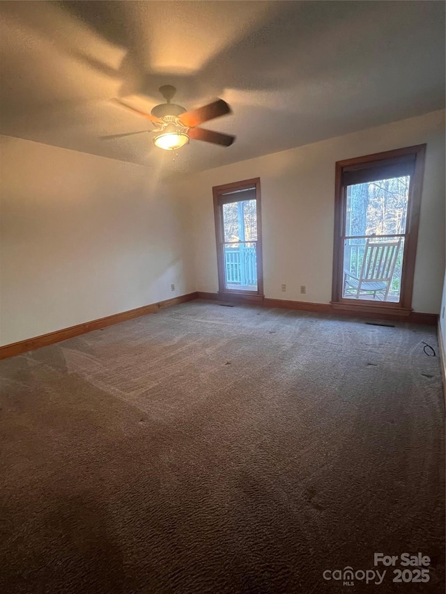 carpeted empty room featuring a textured ceiling and ceiling fan