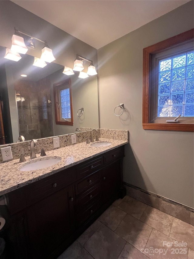 bathroom with vanity and a shower with door