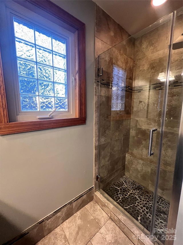 bathroom featuring a shower with shower door