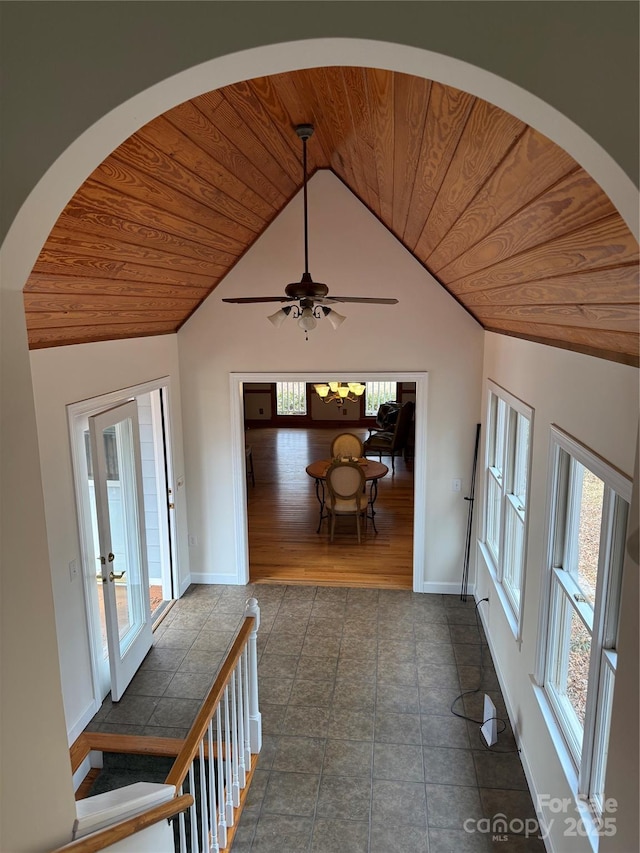 hallway with lofted ceiling, plenty of natural light, and wooden ceiling