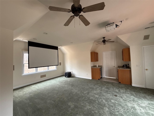 carpeted cinema featuring lofted ceiling and ceiling fan